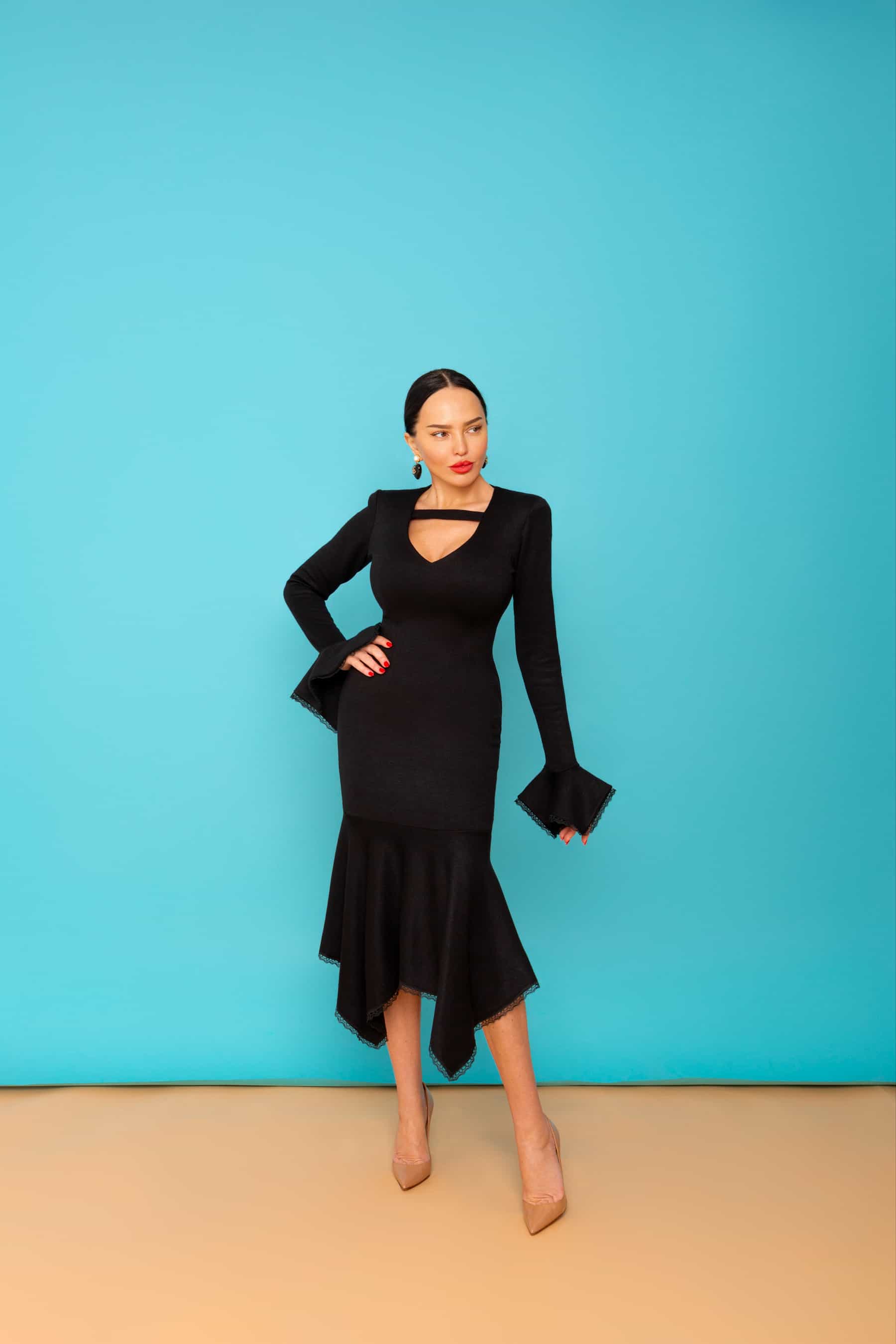 Black dress with asymmetric frill on the bottom and on the sleeves